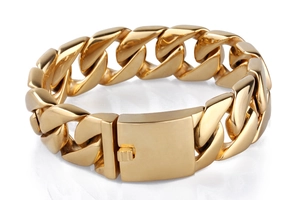 Detailed close-up of a polished gold Cuban link chain bracelet with a square box clasp