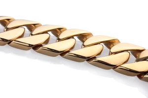 Close-up of polished gold Cuban link chain showing smooth metallic mirror finish