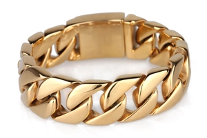 Close-up of a wide gold-plated stainless steel Cuban link bracelet with polished finish