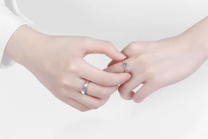 Close-up of a couple wearing S925 silver moissanite rings in a minimalist design
