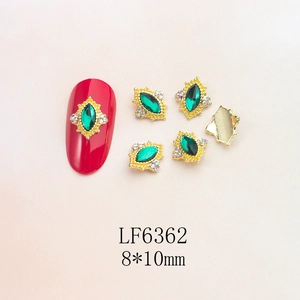 Macro detail of 8x10mm green marquise nail rhinestone with micro-pave gold alloy base
