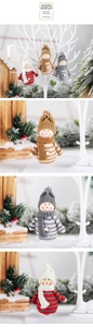 Detailed view of handmade knitted snowman Christmas tree ornaments with striped scarves