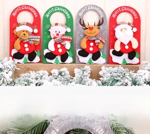 Close-up of four felt Christmas door hangers featuring bear, snowman, deer, and Santa Claus