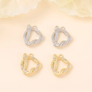Detailed macro view of snake-shaped jewelry charms with gold and silver plating and zircon