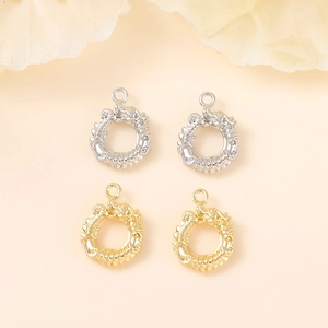 Detailed view of circular dragon pendants in polished gold and silver metal finishes