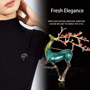 Elegant gold reindeer brooch with blue enamel and red plum blossom details