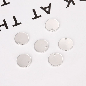 Detailed view of six round silver pendants with smooth mirror polish and single hole design