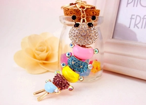 Close-up of colorful rhinestone caterpillar keychain with gold metal base and chain