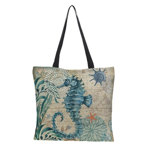 Detailed view of linen tote bag fabric with sea horse and nautical map printed patterns