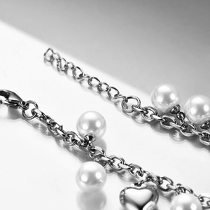 Minimalist stainless steel chain bracelet with white pearls and a heart pendant