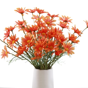Realistic orange artificial daisy bouquet in a white vase for home decor and wedding