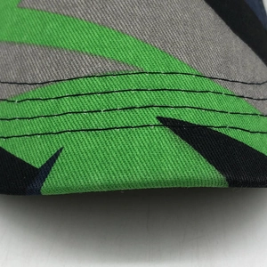 Macro detail of geometric camouflage twill fabric with four-row reinforced stitching on brim