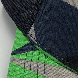 Close-up of geometric camo fabric and breathable mesh stitching on baseball cap