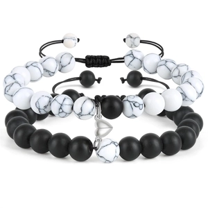 Close-up of magnetic heart clasp on couples bead bracelets with pink crystal and matte stone