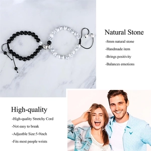 Detail of adjustable couple bracelets with 8mm natural stones and magnetic heart charm