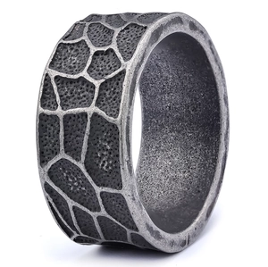 Macro shot of vintage silver ring featuring wide giraffe texture and oxidized steel finish