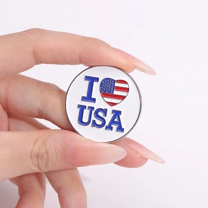 Round metal badge featuring I Love USA text and American flag heart pattern on white