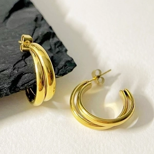Modern double hoop earrings in polished 18k gold finish with layered circular design