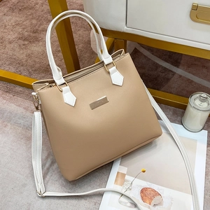 Classic cream beige and white tote bag with gold hardware from a 45-degree angle view