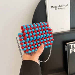 Detailed close-up of handmade acrylic beaded bag in red and blue with silver metal chain strap