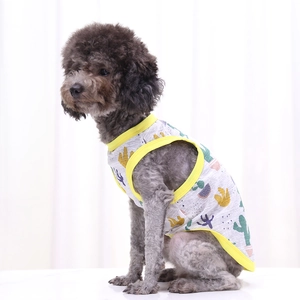 Detail of dog vest with colorful cactus print and yellow trim on a gray poodle