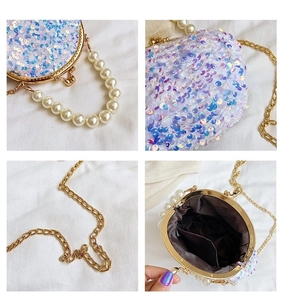 Detail of white iridescent sequin shell bag with pearl handle and metal clasp