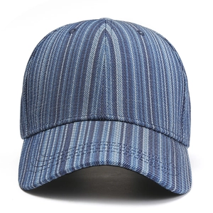 Close-up of blue striped denim texture and reinforced multi-row stitching on the baseball cap
