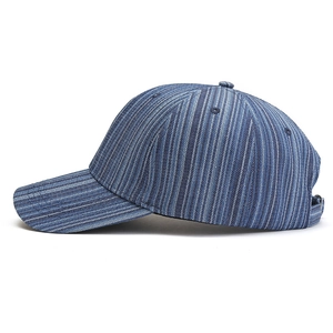 Detail of blue striped cotton baseball cap showing side profile and textured canvas fabric
