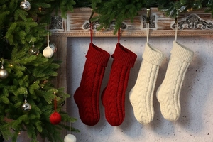 Cozy Christmas stockings in red and cream hanging on a fireplace mantel for home decor