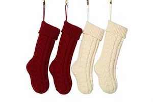 Set of four red and off-white cable knit Christmas stockings with hanging loops