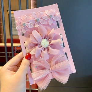 Detailed close-up of a three-piece set of pink lace flowers and mesh bow baby headbands