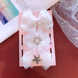 Detailed view of 3-piece white baby headband set with lace bows and rhinestones