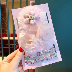 Detail of pink floral headband gift set featuring mesh flowers and lace embroidery