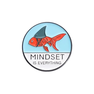 Enamel pin featuring a goldfish with a shark fin and 'MINDSET IS EVERYTHING' text