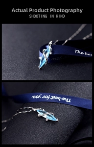Macro detail of marquise-cut blue crystal pendant on a silver-plated vintage necklace