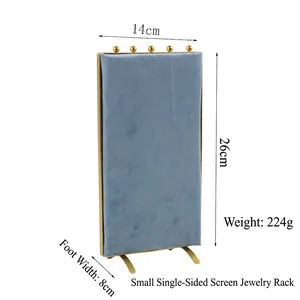 Blue velvet jewelry display screen with gold metal frame for earring storage