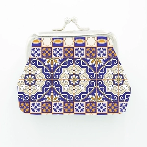 Detail of Moroccan style coin purse featuring blue and yellow mosaic tile patterns
