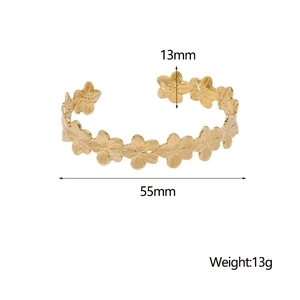Detail showing 55mm diameter and 13mm width of the gold floral stainless steel bangle