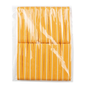 Macro shot of orange nail sponge buffer blocks with white stripes in clear plastic packaging