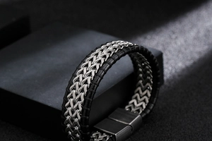 Detailaufnahme des Herrenarmbands aus Leder und Stahl auf einem schwarzen Stein