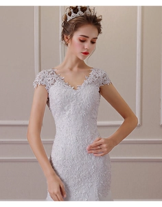 Close-up of elegant V-neck lace wedding dress with intricate floral embroidery details
