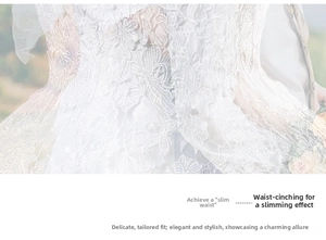 Dettaglio dei ricami floreali e del taglio in vita dell'abito da sposa in pizzo bianco