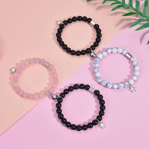 Detail of magnetic heart clasp connecting beaded star bracelets for couples
