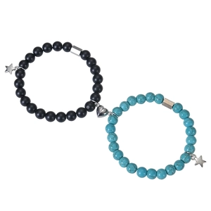 Detail of couple magnetic bracelets with black and turquoise beads and heart charms