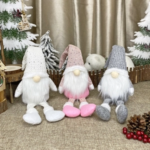 Three Nordic Christmas gnomes with long legs and sequined hats for holiday decoration