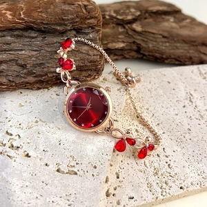 Elegant rose gold butterfly watch with red gemstone dial and adjustable bracelet