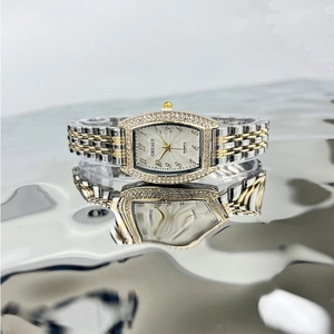 Women's tonneau emerald quartz watch with rhinestone-encrusted silver-gold tone band