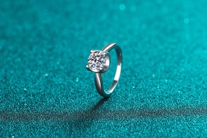 Macro shot of silver S925 sterling silver moissanite ring with classic 4-prong setting