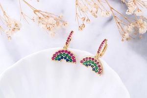 Detailed close-up of rainbow arc earrings with multi-color zircon pavé on gold plating
