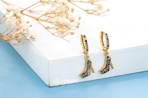 Close-up of gold high heel earrings featuring colorful cubic zirconia pave crystals